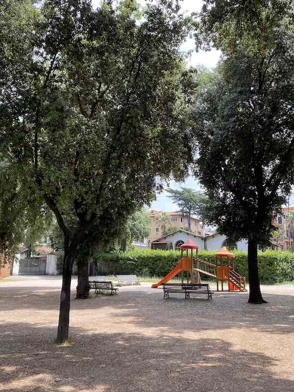 small playground in Rome Italy with colorful slides