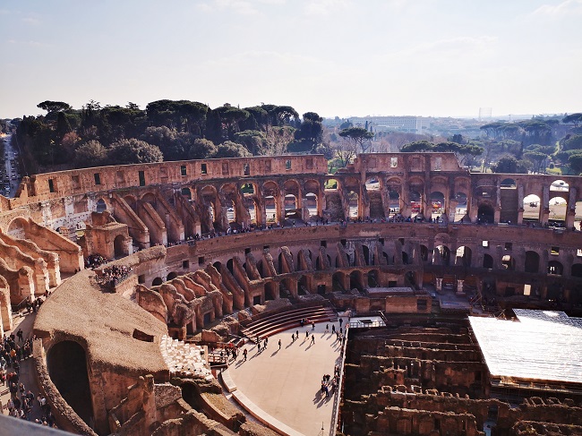 View over the inside of the Colosseum from top floor with arches and the arena floor