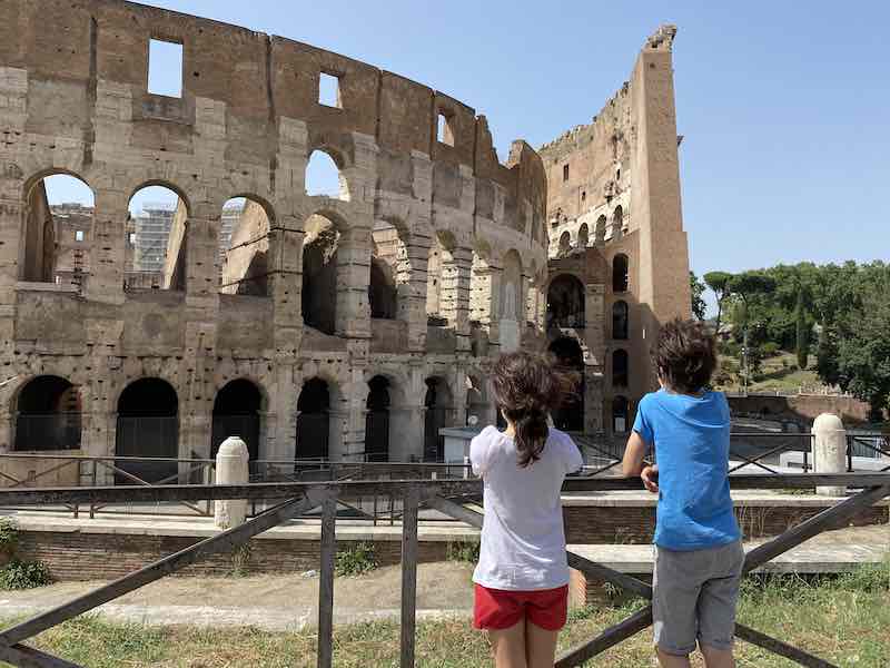 boy and girl tween in front of Rome Colosseum