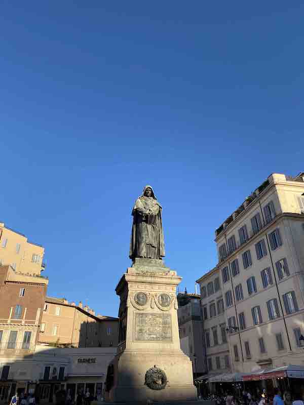 Statue of Giordano Bruno in Campo de' Fiori Rome, Italy with blue sky