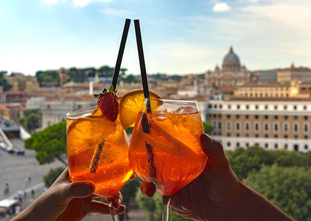 two glasses of sprits with background os Vatican from Rome rooftop bar