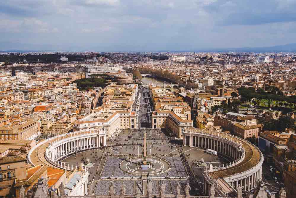 Aerial view over Rome with Vatican square in foreground and colosseum fat in the back