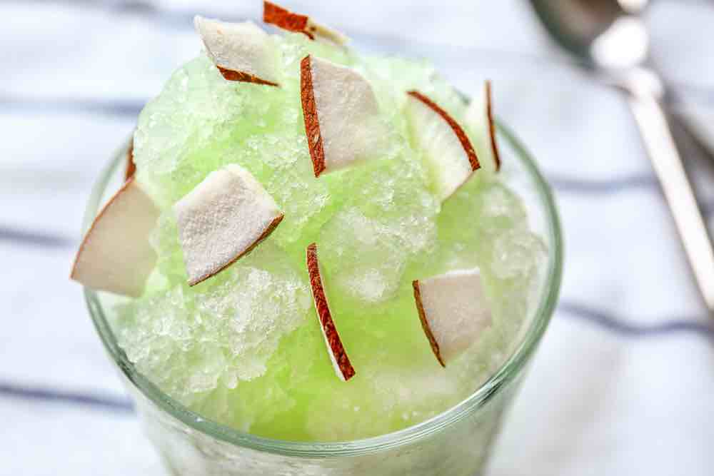 shaved ice dessert with coconut and green syrup