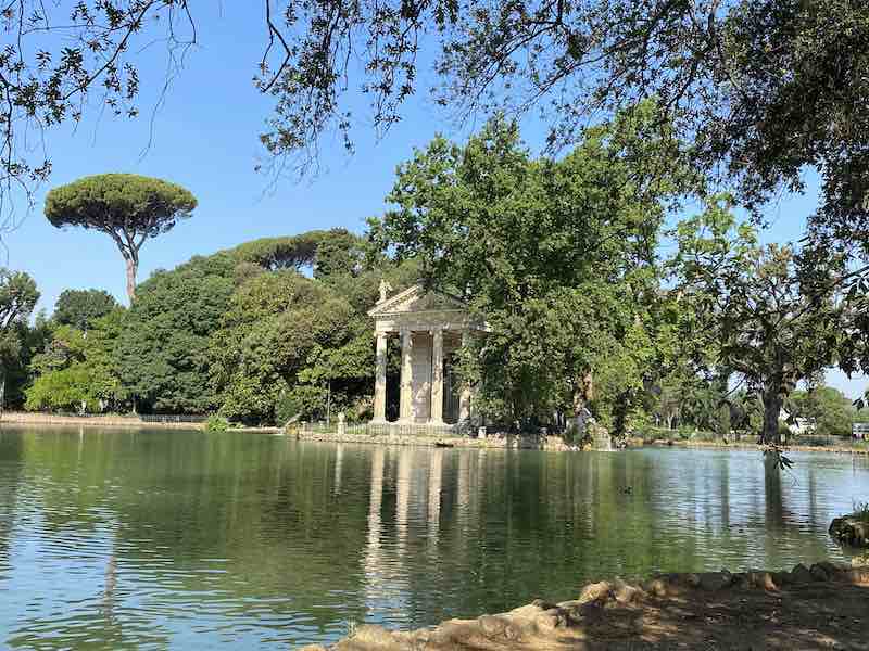 Pond in Villa Borghese Gardens Rome with small decorative temple overlooking the water
