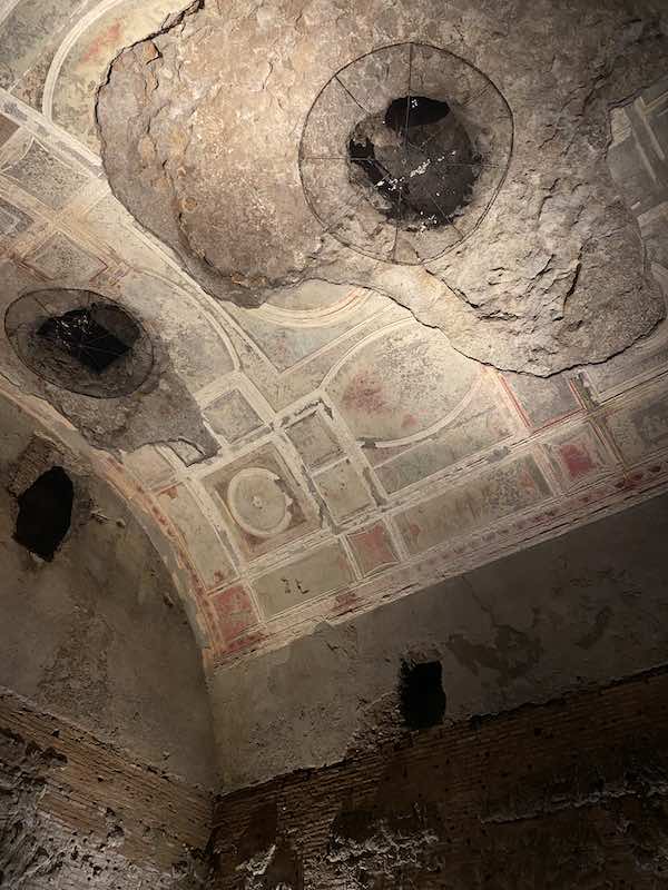 Ceiling frescoes in Domus Aurea Rome with holes created by the thieves 