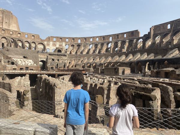Two children, one boy and one girl, inside Rome Colosseum