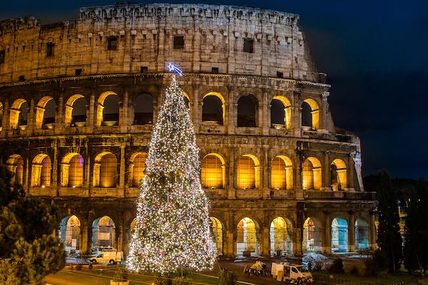 Christmas Tree in front of Rome Colosseum at night with lights