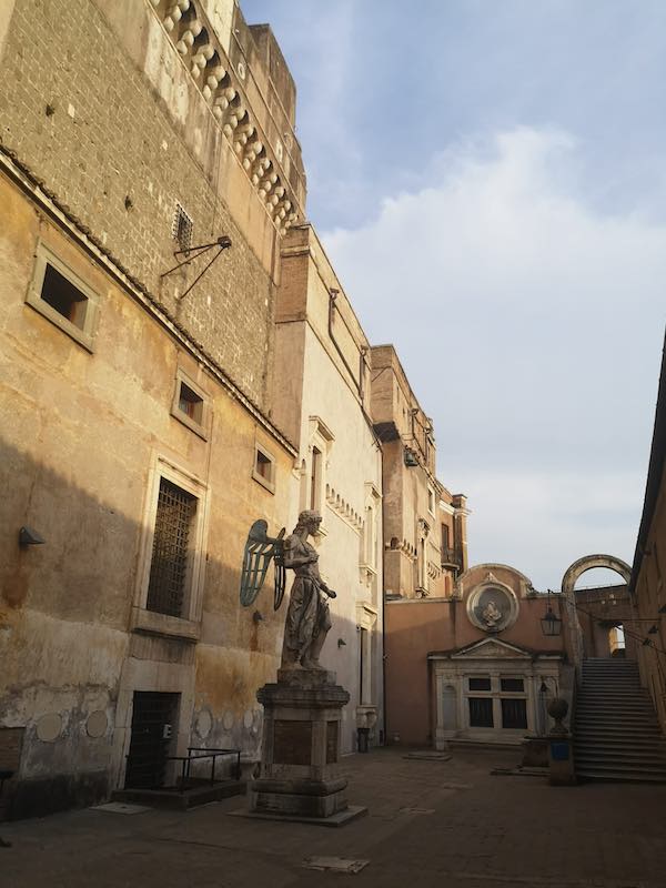 Inner courtyard in Sant'aAngelo Castle with a tall statue of an angel