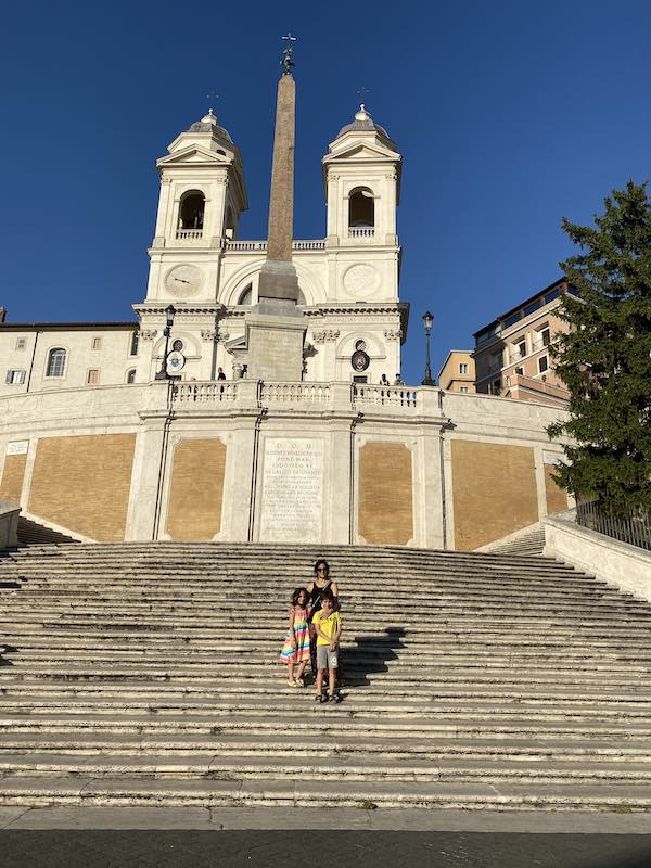 Woman and two kids on Spanish Steps photographed while visiting Rome with kids in summer