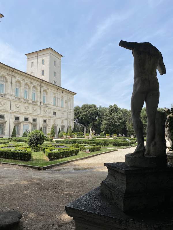 Back entrance to the Borghese Gallery with outdoor statue in the foreground