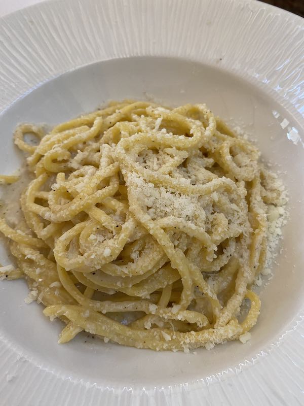 cacio e pepe pasta in white plate