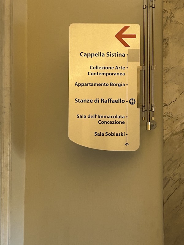 Info sign directing visitors to the Sistine Chapel