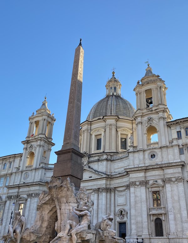 Obelisk on top of the Fountain of the Four Rivers in Rome with church of St Agnes in the background