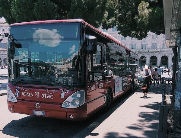 Public transport Rome - dark red bus stationed at Rome Termini bus Terminus