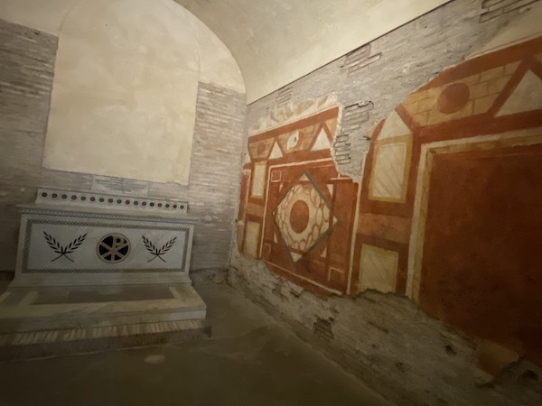 Red frescoes and altar inside the Roman houses of the Caelian Hill in Rome, Italy