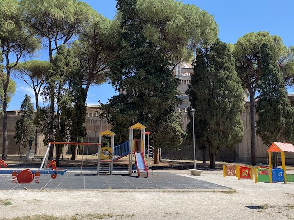 Children playground in front of Castel Sant'Angelo Rome under pine trees