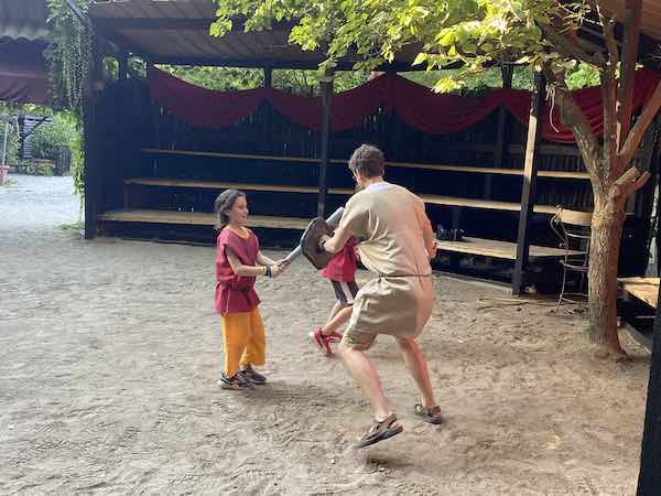 My kids and my husband fighting like gladiators in Rome's gladiator school