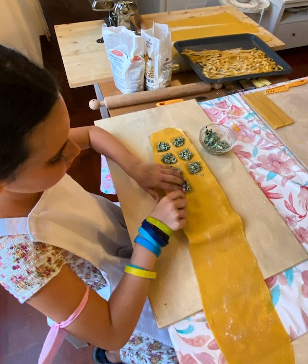 My daughter making pasta during a pasta making class in Rome