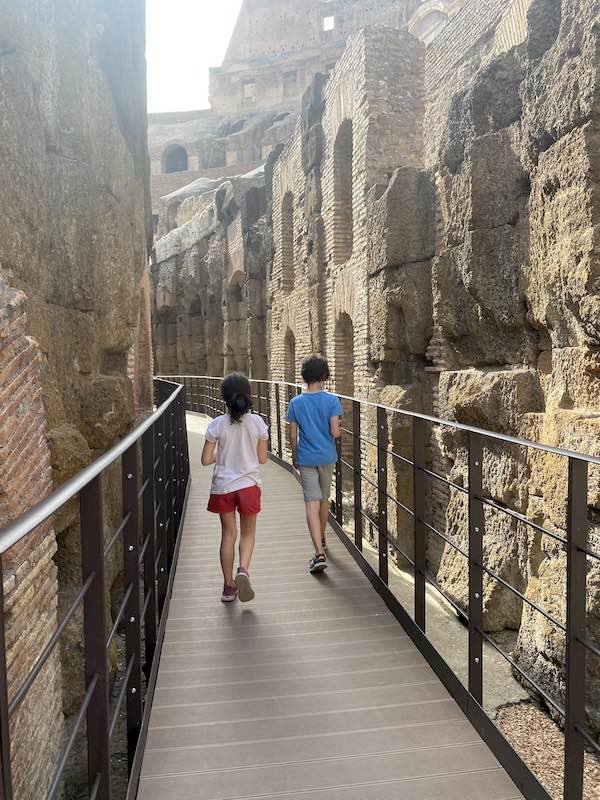 Kids walking in the underground part of the Colosseum