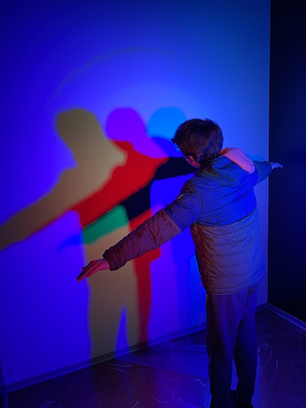 My son playing with light in Rome Museum of Illusions